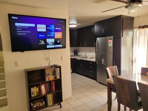 a kitchen with a large tv on the wall at Relaxing Place Near the Sea in Ensenada