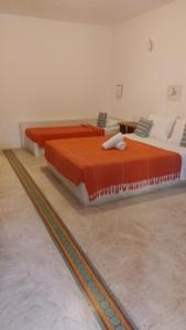 dos camas sentadas una al lado de la otra en una habitación en Pousada Vila do Beco, en Arraial d'Ajuda