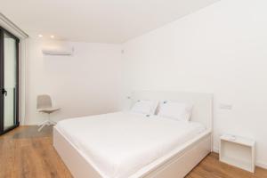 Ένα ή περισσότερα κρεβάτια σε δωμάτιο στο Luxo à Beira-Mar na Ria Formosa