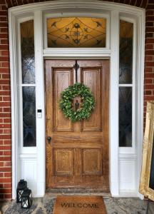 a wooden door with a wreath on it at South Court Inn in Luray