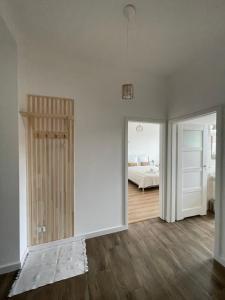 an empty room with a bed and a door to a bedroom at Chopin's Apartment in Bielsko-Biala