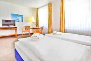 Postel nebo postele na pokoji v ubytování Strandhotel Bansiner Hof