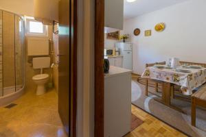 a kitchen with a sink and a table in a room at Apartments Matilda in Dramalj +78 photos