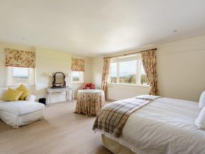 a bedroom with a bed and a couch and a table at Green Craig in Aberlady