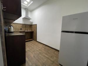 a kitchen with a refrigerator in a room at NO PROBLEM in Yerevan