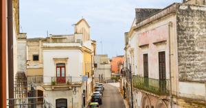 a view of an alley with parked cars in a city at Tre Balconi - Casa Vacanza Salento in Carmiano