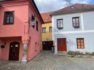 a row of colorful houses on a cobblestone street at Apartmany u Synagogy in Třebíč