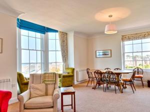 a living room with a table and chairs at Inchgarry Court in North Berwick
