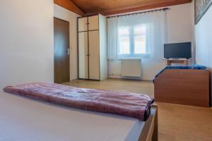 a bedroom with a large bed and a large window at Apartments Matilda in Dramalj