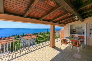 a balcony with a table and chairs and a view of the ocean at Apartments Matilda in Dramalj