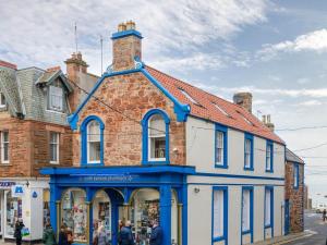 a blue and white building on the side of a street at Curlew in North Berwick