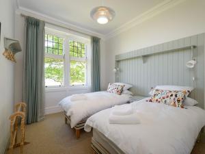 a bedroom with two beds and a window at Havana in North Berwick