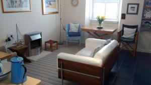 a living room with a couch and a fireplace at Harbourside Cottage in North Berwick