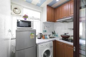 a kitchen with a refrigerator and a washing machine at 3room charming apt,8pax in Hong Kong