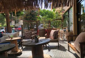 a patio of a restaurant with tables and chairs at Rhodes Backpackers Boutique Hostel and Apartments in Rhodes Town