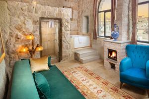 a living room with a couch and a fireplace at Cappadocia hotel Megaron cave in Ortahisar