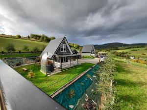 an aerial view of a house with a swimming pool at Domki Dwa in Limanowa