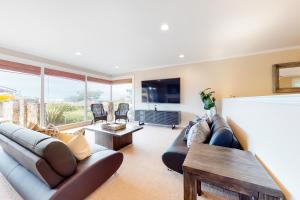 a living room with a couch and a tv at Pradera Estate in Carmel
