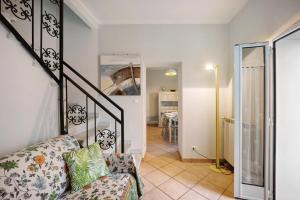 a living room with a couch and a staircase at The Family Free Parking in Alassio in Alassio