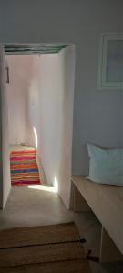 a small room with a bed and a stair case at WabiSabi Serifos Chora w/ Spectacular Sea Views in Serifos Chora