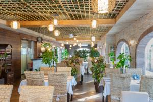 a restaurant with tables and chairs and plants at Casa Lili in Moraira