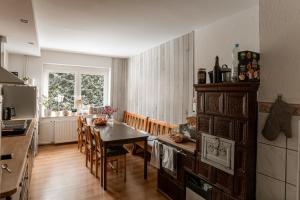 a kitchen and dining room with a table and chairs at Dom Gościnny Tatra Nova in Długopole-Zdrój