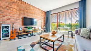 a living room with a brick wall at Gdynia Nowe Orłowo, Sun & Snow in Gdynia