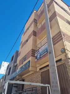 a building with a sign on the side of it at شقق مفروشة الفري in Laayoune