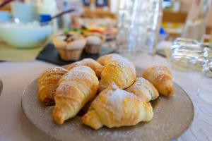 a plate of croissants and pastries on a table at Pension Haus in der Sonne in Fieberbrunn