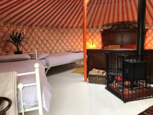 a room with a bed in a yurt at Gilfach Gower Farm Luxury Yurt with Hot Tub in Ammanford