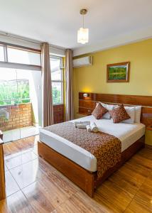 a bedroom with a bed and a large window at Copasu Hotel in Puerto Maldonado