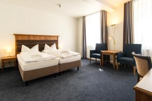 Postel nebo postele na pokoji v ubytování Hotel am Fischerstrand