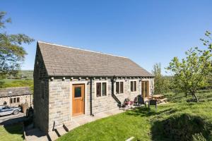 a small brick house with a yard at NEW BARN CONVERSION WITH PRIVATE HOT TUB in Halifax