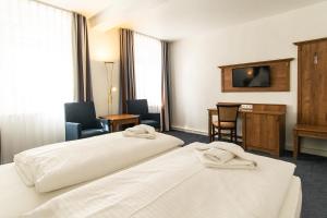 Postel nebo postele na pokoji v ubytování Hotel am Fischerstrand