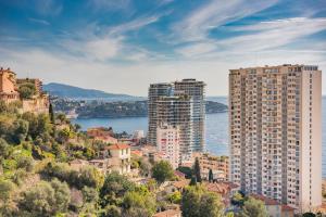 a city with tall buildings and a body of water at Terrasse Vue Mer, 5mn Monaco, Parking - AN in Beausoleil
