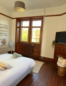 Łóżko lub łóżka w pokoju w obiekcie O'Cottage suite Familiale