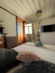 a bedroom with a large bed and a large window at O'Cottage suite Familiale in Annonay