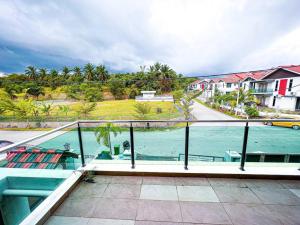 a balcony with a view of a body of water at Mekming Lodging - Homestay in Malacca