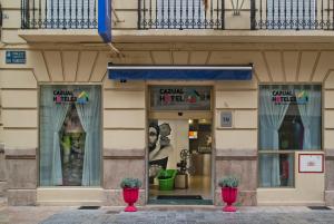 a building with two windows and a vase on the ground at Casual del Cine Valencia in Valencia