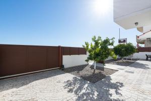 a patio with a fence and a tree at Casa Marinella in Gennadi
