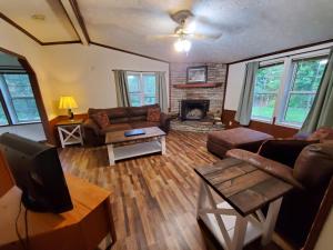 a living room with a couch and a fireplace at Forest Hills ATV Resort in Forest Hills