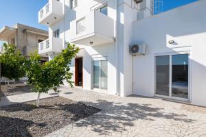 a white building with a tree in front of it at Casa Marinella in Gennadi