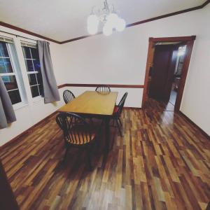 a dining room with a wooden table and chairs at Forest Hills ATV Resort in Forest Hills