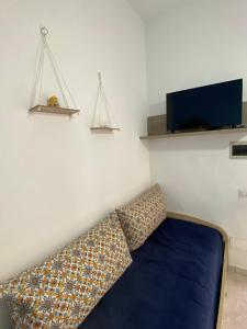 sala de estar con sofá y TV en La Casetta di Azzurra, en Canneto