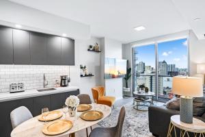 a kitchen and living room with a table and chairs at - Casiola Studio's - near Cruise Terminal, Bayfront Park and Kaseya Center in Miami