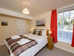 a bedroom with a bed with two towels on it at Southcot in North Berwick