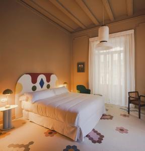 a bedroom with a large bed and a large window at Casa Clarita in Valencia