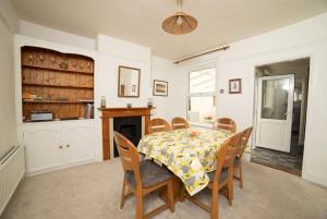 a dining room with a table and chairs and a fireplace at Yarborough in East Cowes