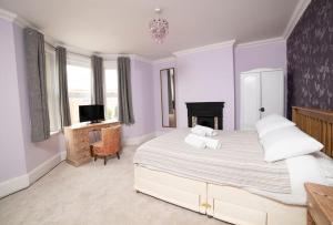 a bedroom with a large bed and a tv at Yarborough in East Cowes