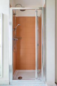 a shower in a bathroom with orange tile at Sweet Bright Flats - City Center in Porto